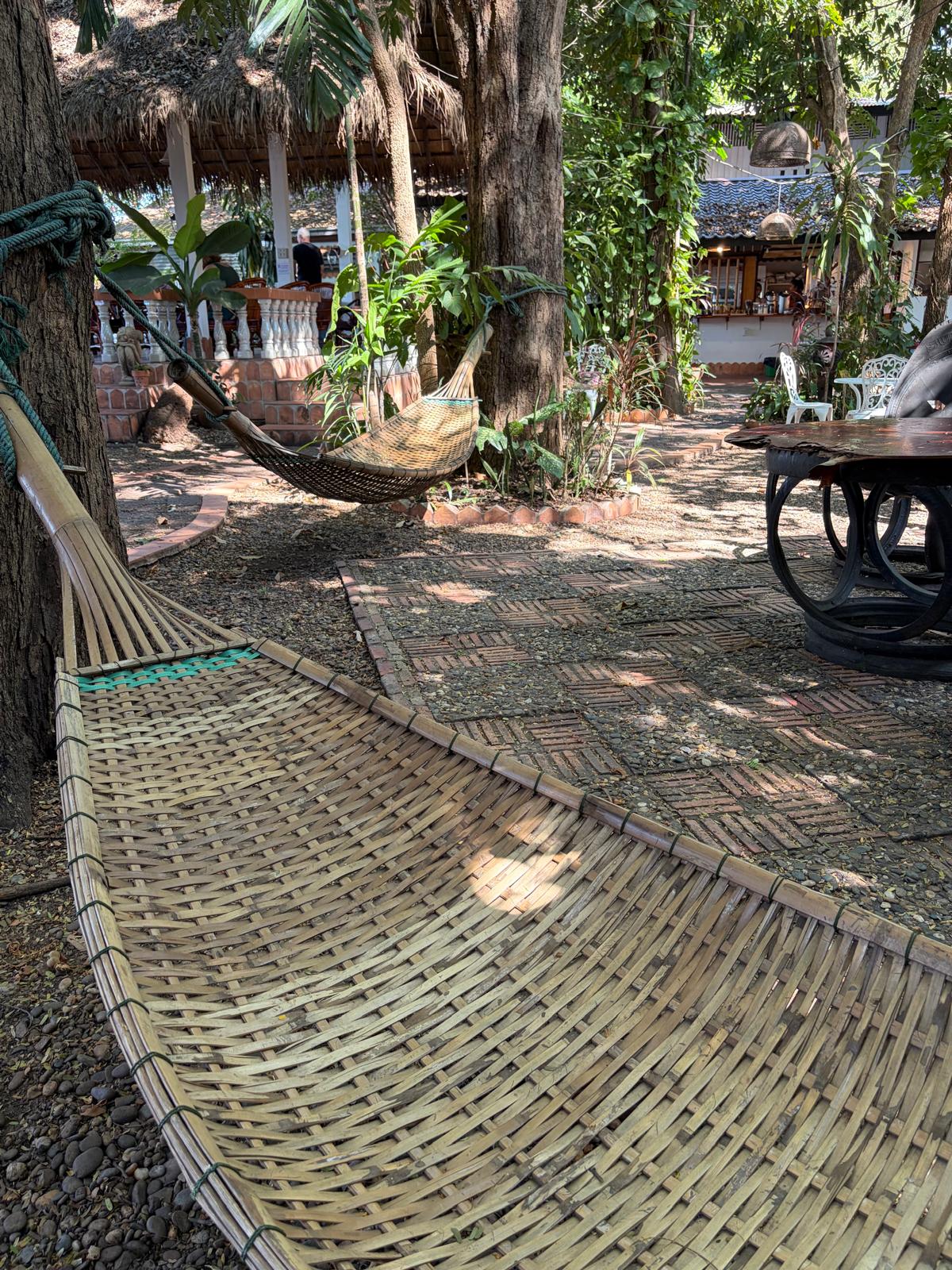 Hammock in tropical gardens at Mut Mee Guesthouse overlooking the Mekong
